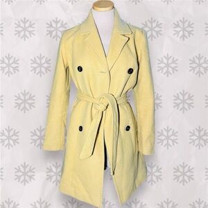 Yellow trench coat with black buttons